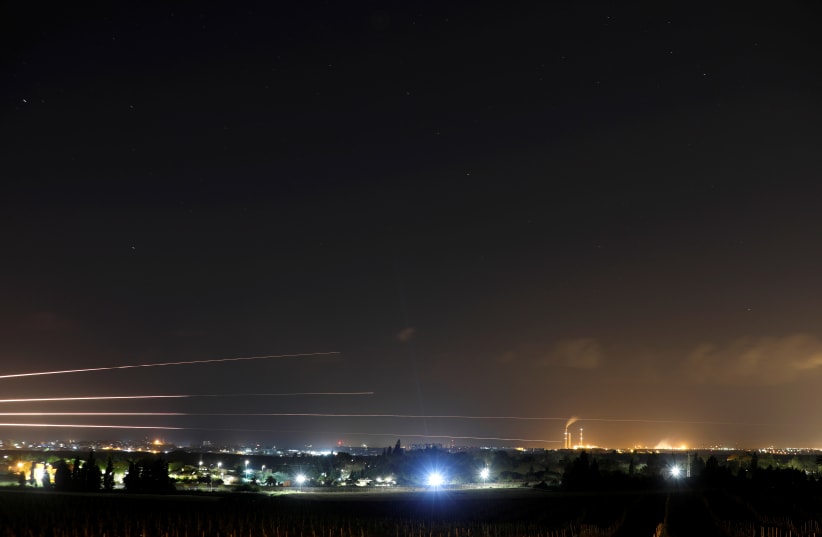 Streaks of light are pictured as rockets are launched from the Gaza Strip towards Israel, as seen from the Israeli side of the border March 25, 2019 (photo credit: AMIR COHEN/REUTERS)