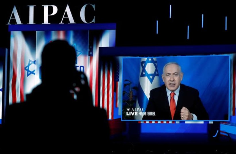 Speaking via satellite feed from Israel, Israeli Prime Minister Benjamin Netanyahu addresses AIPAC in Washington, U.S., March 26, 2019 (photo credit: KEVIN LAMARQUE/REUTERS)