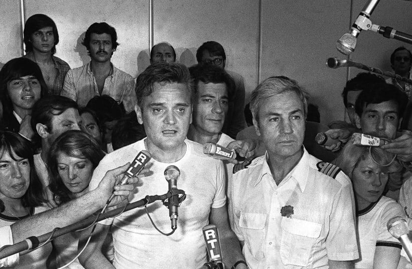Michel Bacos (R) speaks to the media in 1976 (photo credit: AFP PHOTO)