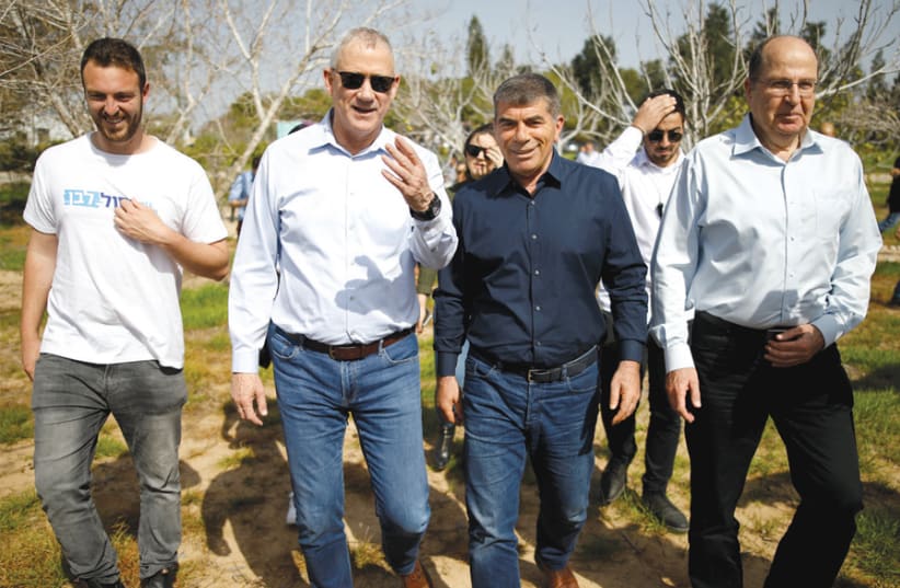 Benny Gantz, head of the Blue and White Party, visits Kibbutz Kfar Aza near the Gaza Strip on March 13 with party candidates Gabi Ashkenazy and Moshe Ya’alon (photo credit: AMIR COHEN/REUTERS)