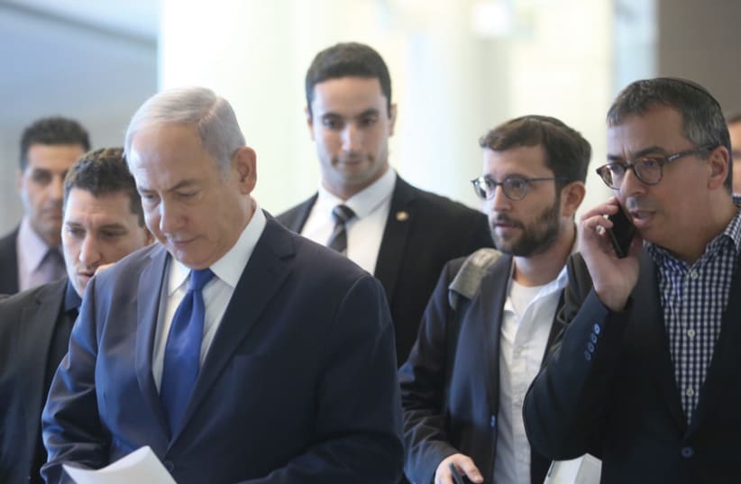 Yonatan Urich stands to the right and a bit behind PM Netanyahu while walking in the Knesset (MARC ISRAEL SELLEM) (photo credit: MARC ISRAEL SELLEM)