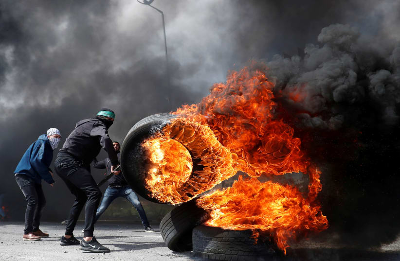 Palestinian rioters in clashes near Ramallah (REUTERS/Mohamad Torokman) (photo credit: REUTERS/MOHAMAD TOROKMAN)