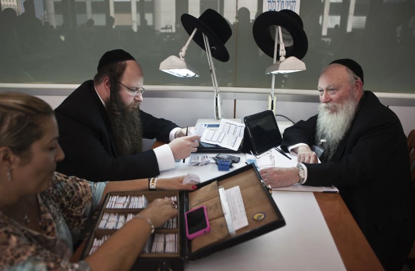 Ultra-Orthodox Jews work in the trading room of Israel's diamond exchange in Ramat Gan near Tel Aviv October 30, 2012. Diamond manufacturing is a dwindling trade in Israel. The country has one of the world's hottest diamond exchanges, but polishers and cutters of the precious stones have been replac (photo credit: NIR ELIAS / REUTERS)