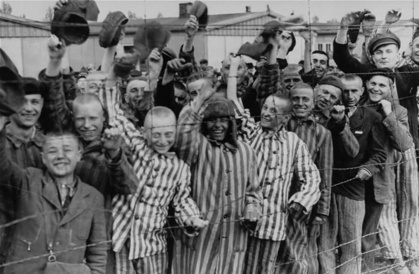 Survivors of the Nazi death camp in Dachau cheer approaching U.S. troops (photo credit: US NATIONAL ARCHIVES AND RECORDS ADMINISTRATION/WIKIMEDIA COMMONS)