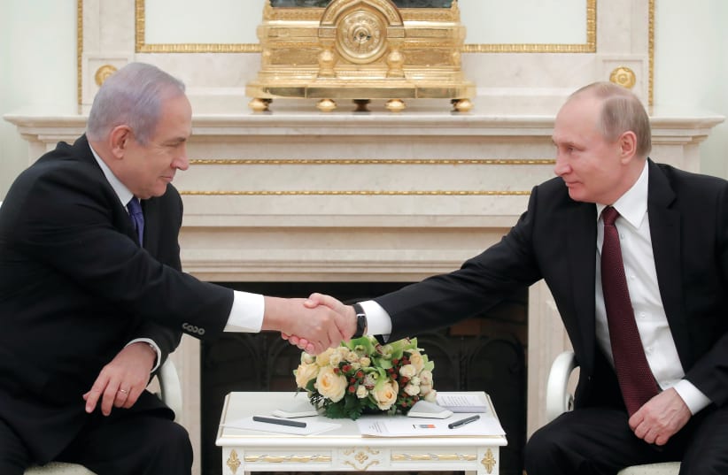 RUSSIAN PRESIDENT Vladimir Putin shakes hands with Prime Minister Benjamin Netanyahu during a meeting in Moscow last month. (photo credit: REUTERS)