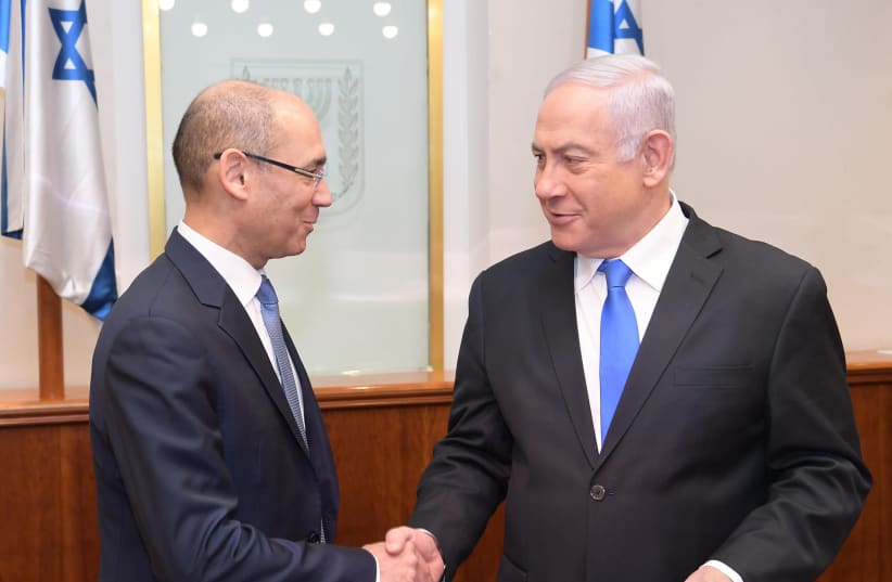 Amir Yaron (L) delivers a report to Benjamin Netanyahu (R) (photo credit: AMOS BEN-GERSHOM/GPO)