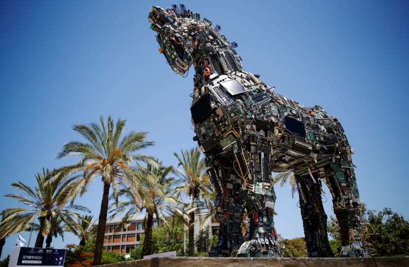 A "Cyber Horse", made from thousands of infected computer and cell phone bits, is displayed at the entrance to the annual Cyberweek conference at Tel Aviv University, Israel June 20, 2016 (photo credit: REUTERS/AMIR COHEN)