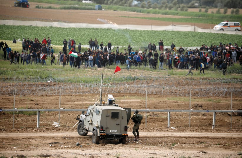 GAZAN PROTESTERS at the border fence on Saturday. (Reuters) (photo credit: REUTERS)