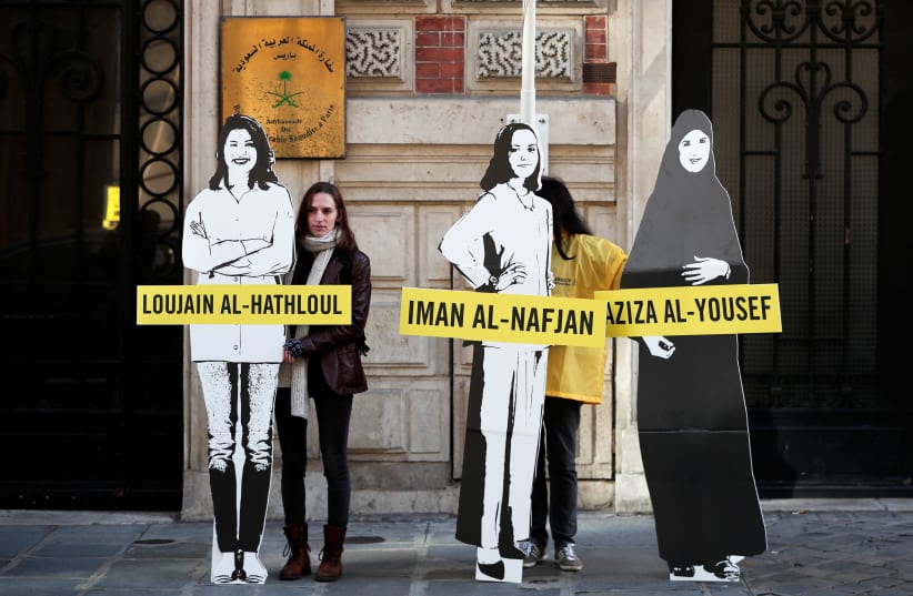 Demonstrators from Amnesty International stage the protest on International Women's day to urge Saudi authorities to release jailed women's rights activists Loujain al-Hathloul, Eman al-Nafjan and Aziza al-Yousef outside the Saudi Arabian Embassy in Paris, France, March 8, 2019 (photo credit: REUTERS/BENOIT TESSIER)