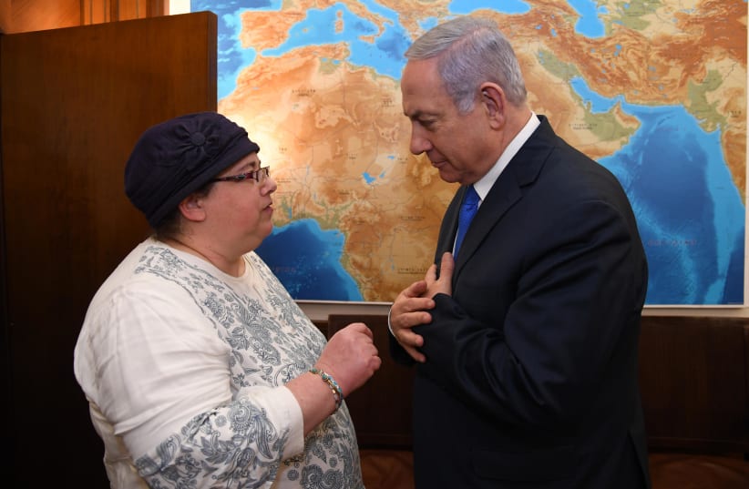 Prime Minister Benjamin Netanyahu and Osna Baumel, sister of Zachary Baumel (photo credit: HAIM ZACH/GPO)
