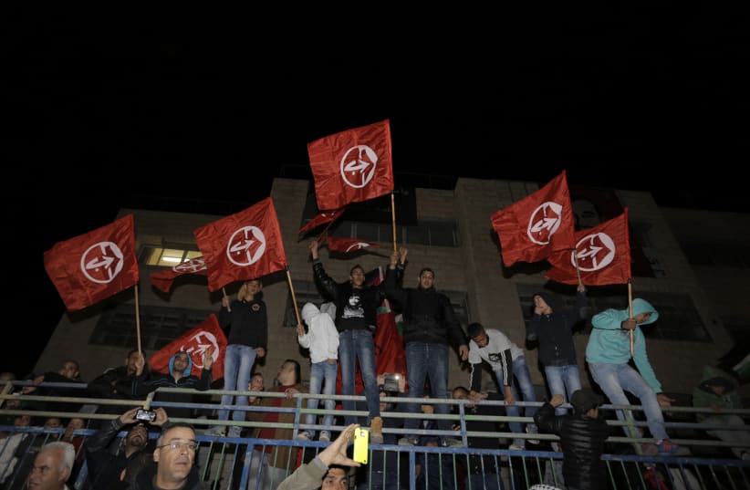 Palestinians hold Popular Front for the Liberation of Palestine (PFLP) flags, December 23, 2013 (photo credit: AMMAR AWAD / REUTERS)