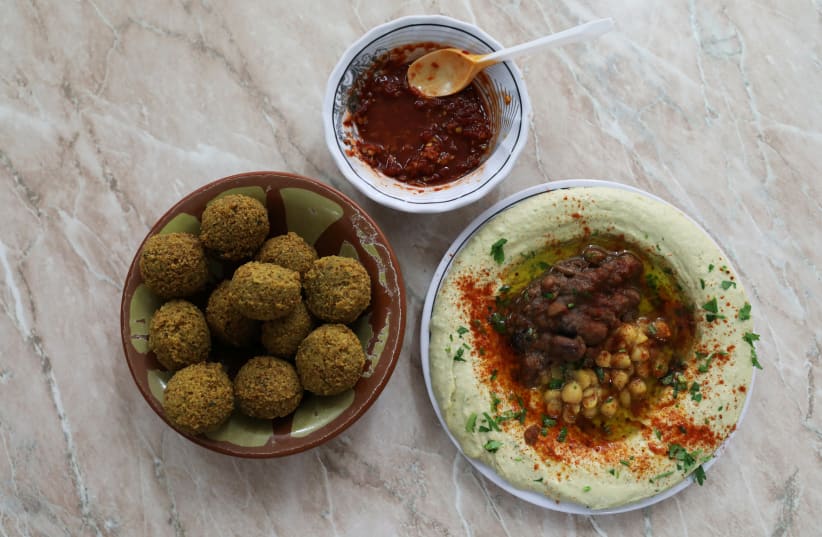 Chickpea-based hummus and falafel at the famed Abu Shukri restaurant in Jerusalem's Old City (photo credit: AMMAR AWAD / REUTERS)
