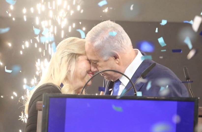 Prime Minister Benjamin Netanyahu emraces his wife Sara after elections results, April 9th, 2019 (photo credit: MARC ISRAEL SELLEM/THE JERUSALEM POST)