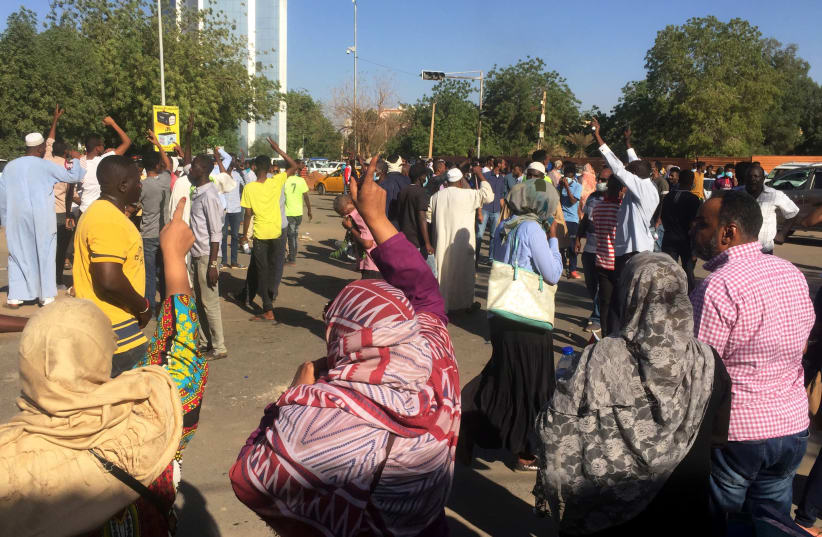 Sudanese demonstrators chant slogans during a protest demanding Sudanese President Omar Al-Bashir to step down in Khartoum, Sudan April 6, 2019 (photo credit: REUTERS/STRINGER)