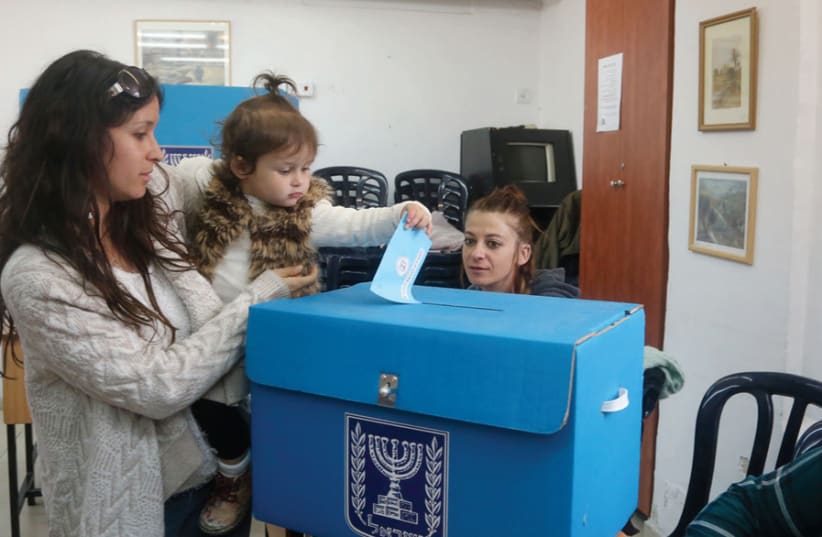 A woman votes in Jerusalem (photo credit: MARC ISRAEL SELLEM)