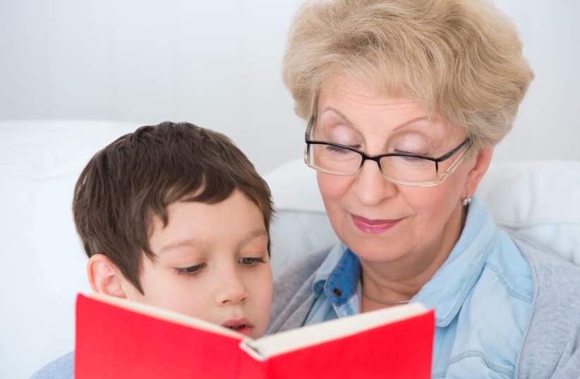 A bubbie reads to her grandchild (illustrative) (photo credit: INGIMAGE)