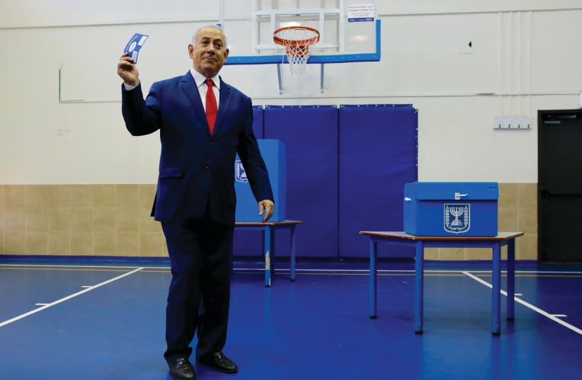 PRIME MINISTER Benjamin Netanyahu votes Tuesday in Jerusalem (photo credit: REUTERS)