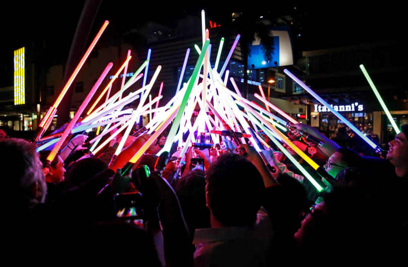 Star Wars enthusiasts huddle with their lightsabers after participating in Earth Hour at Taguig City, Philippines, March 30, 2019 (photo credit: REUTERS/ELOISA LOPEZ)