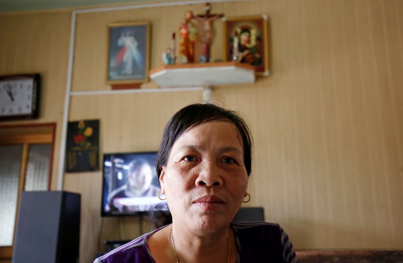 Nguyen Thi Vy, stepmother of Doan Thi Huong, the Vietnamese suspect in Kim Jong Nam's murder, receives a phone call in her house in Nam Dinh province, Vietnam April 1, 2019 (photo credit: KHAM / REUTERS)