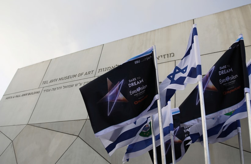 Israeli flags and flags bearing the logo of the 2019 Eurovision song contest flutter outside the Tel Aviv Museum of Art, during the Eurovision Semi-Final allocation draw, in Tel Aviv. (photo credit: CORINNA KERN/REUTERS)