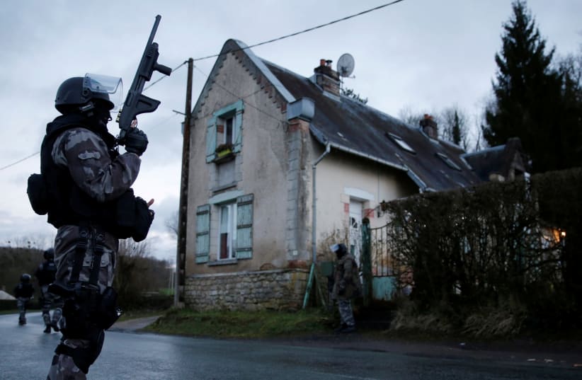  Members of the French GIPN intervention police forces secure a neighbourhood in Corcy, northeast of Paris January 8, 2015. French anti-terrorism police converged on an area northeast of Paris after two brothers suspected of being behind an attack on the satirical newspaper Charlie Hebdo were spotte (photo credit: CHRISTIAN HARTMANN/REUTERS)