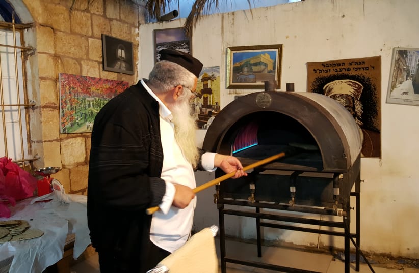 Baking matzah for the Passover holiday at the Meir Moshe Levy Synagogue in the Nachlaot neighborhood of Jerusalem, April 11, 2019 (photo credit: BEN BRESKY)