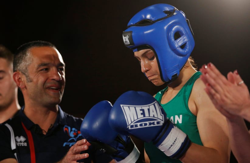 Iranian boxer Sadaf Khadem and coach Mahyar Monshipour react before the fight against French boxer Anne Chauvin during an official boxing bout in Royan, France, April 13, 2019 (photo credit: STEPHANE MAHE / REUTERS)
