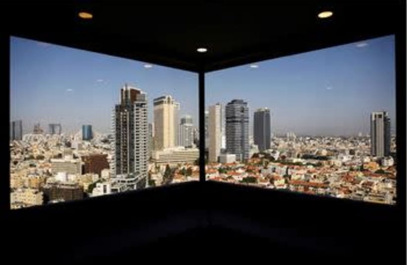 A general view of Tel Aviv's skyline is seen through a hotel window in Tel Aviv, Israel May 15, 2017. (photo credit: AMIR COHEN - REUTERS)