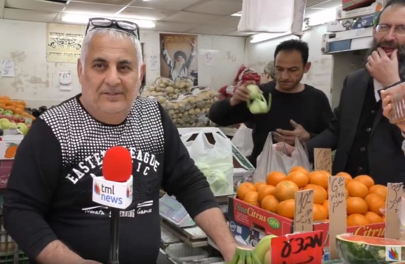 A shopkeeper in Jerusalem's Mahane Yehuda market, April 2019 (photo credit: THE MEDIA LINE)