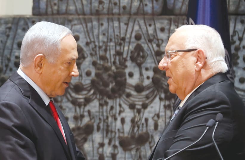 PRESIDENT REUVEN Rivlin and Prime Minister Benjamin Netanyahu face off at the President’s residence in Jerusalem on Wednesday night (photo credit: RONEN ZVULUN/REUTERS)