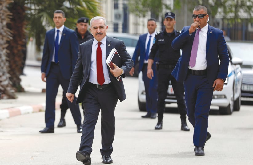 HEADED TOWARD conflict? Palestinian Prime Minister Mohammad Shtayyeh arrives for a cabinet meeting of the new Palestinian government, in Ramallah, earlier this week (photo credit: REUTERS/MOHAMAD TOROKMAN)