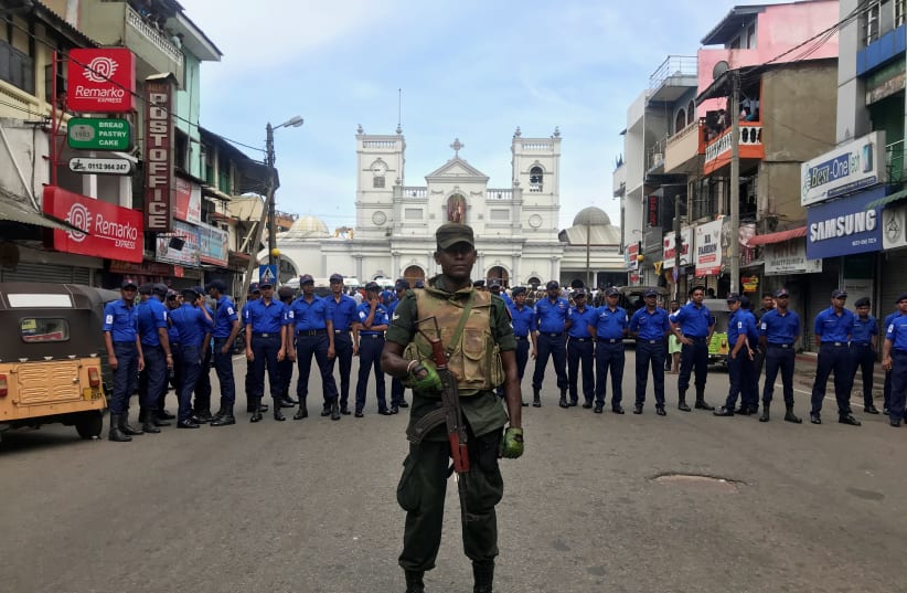 Sri Lankan military officials stand guard in front of the St. Anthony's Shrine, Kochchikade church after an explosion in Colombo, Sri Lanka  (photo credit: DINUKA LIYANAWATTE/REUTERS)