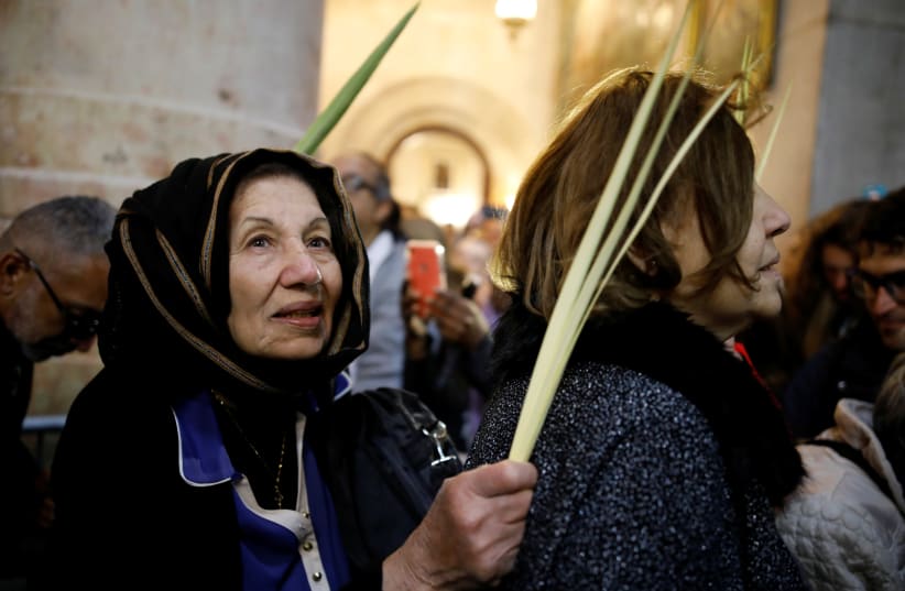 Christian worshippers attend Easter Sunday Mass in Jerusalem’s Holy Sepulcher Church April 21, 2019 (photo credit: AMIR COHEN/REUTERS)