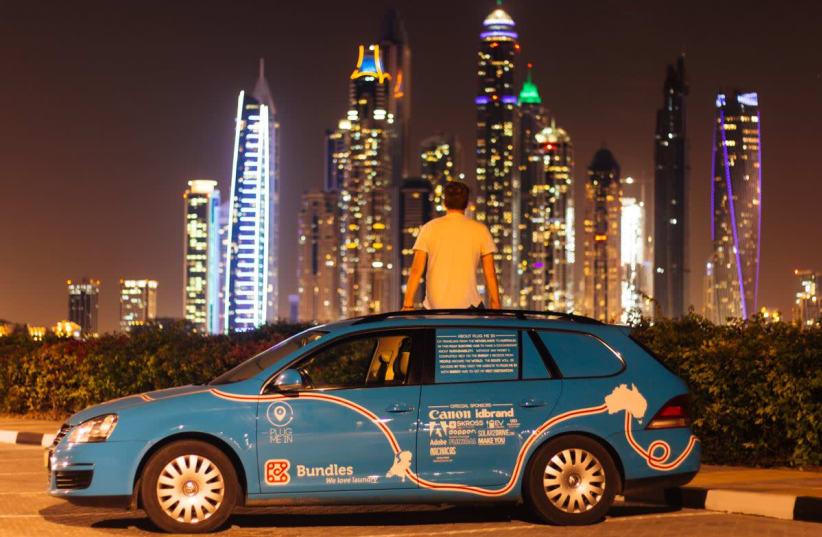 Dutch adventurer Wiebe Wakker on his electric car journey from the Netherlands to Australia, in Dubai, UAE December 2016 in this picture obtained from social media.  (photo credit: REUTERS)