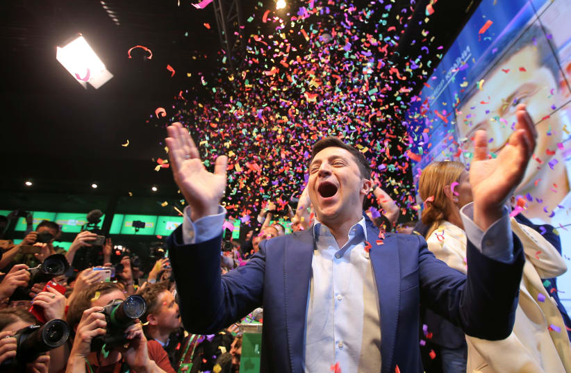 Ukrainian presidential candidate Volodymyr Zelenskiy reacts following the announcement of the first exit poll in a presidential election at his campaign headquarters in Kiev, Ukraine April 21, 2019 (photo credit: REUTERS)