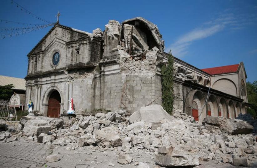 Debris and rubble surround the Santa Catalina de Alejandria Parish after an earthquake the day before in Porac town, Pampanga province, Philippines (photo credit: REUTERS/ELOISA LOPEZ)