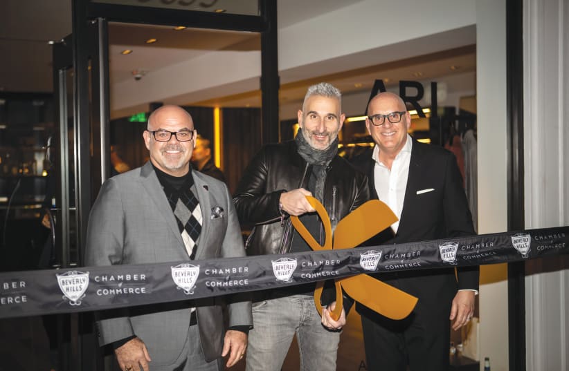 MOSHE BEN-ARI (center) at the opening of his Ari boutique in Los Angeles. (Courtesy) (photo credit: Courtesy)