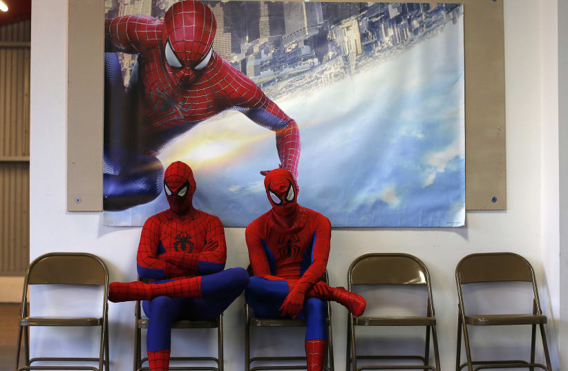 Peter Norbot (L) and Kris Hamilton, dressed up as fictional comic book superhero Spider-Man, wait for their turn to audition to be a part of a promotional campaign for the upcoming release of the new movie "The Amazing Spider-Man 2" in Chicago March 19, 2014 (photo credit: JIM YOUNG/REUTERS)