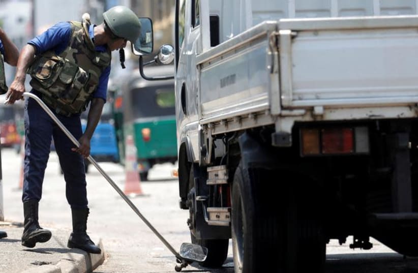 A Sri Lankan navy soldier searches a truck at a check point in Colombo, three days after a string of suicide bomb attacks on churches and luxury hotels across the island on Easter Sunday, in Sri Lanka April 24, 2019 (photo credit: REUTERS/DINUKA LIYANAWATTE)