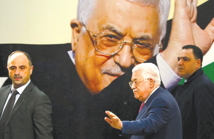 Palestinian Authority President Mahmoud Abbas gestures during a ceremony marking the 54th anniversary of Fatah's founding, in Ramallah on December 31 (photo credit: REUTERS)