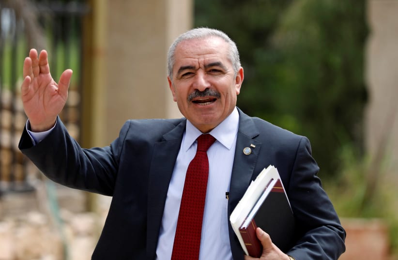 PA Prime Minister Mohammad Shtayyeh gestures as he arrives for a cabinet meeting of the new Palestinian government, in Ramallah, April 15, 2019 (photo credit: MOHAMAD TOROKMAN/REUTERS)