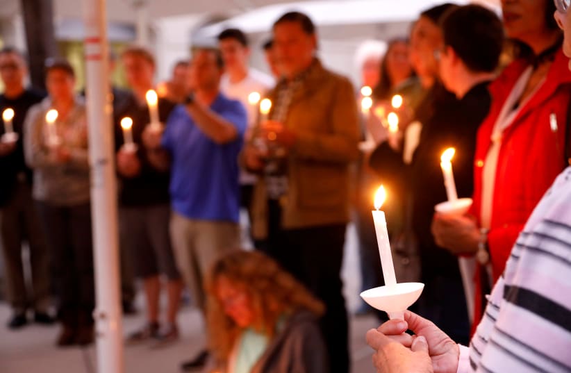 A candlelight vigil is held at Rancho Bernardo Community Presbyterian Church for victims of a shooting incident at the Congregation Chabad synagogue in Poway, north of San Diego, California. (photo credit: JOHN GASTALDO/REUTERS)