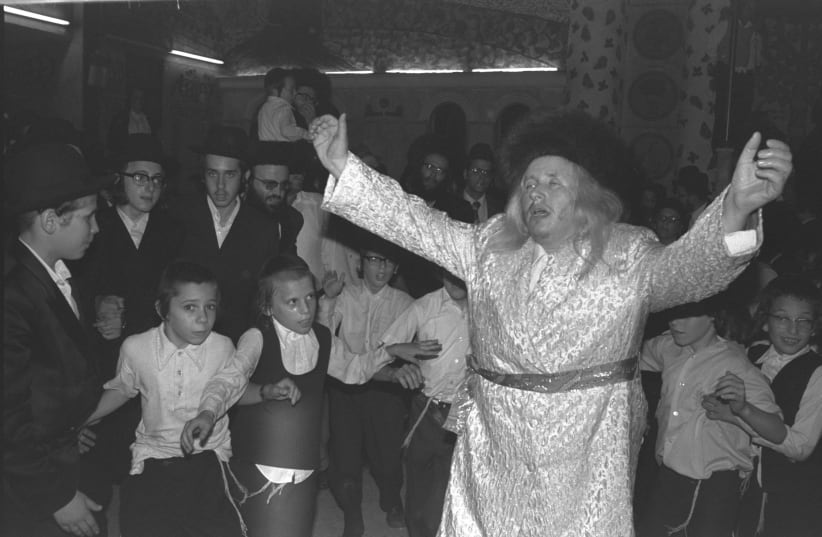The Rebbe of Kaliv and his hassidic followers celebrating the Simchat Beit Hashoeva (water drawing ceremony) during Succot in Rishon LeZion, October 18, 1978 (photo credit: MOSHE MILNER / GPO)
