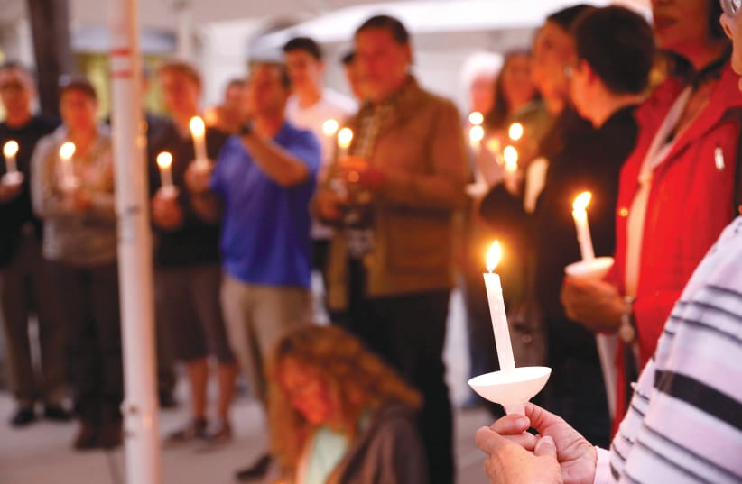 A VIGIL for victims of an attack on a synagogue in California (photo credit: REUTERS)