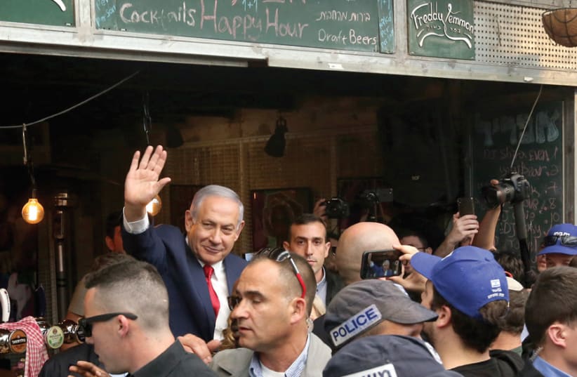 Prime Minister Benjamin Netanyahu campaigns at Jerusalem’s Machane Yehuda Market on April 8 , a day before his reelection (photo credit: MARC ISRAEL SELLEM)