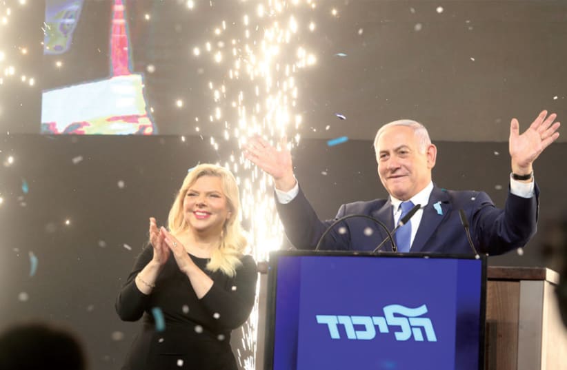 Prime Minister Benjamin Netanyahu and his wife, Sara, thank supporters at a Likud celebratory rally in Tel Aviv on April 10, after it became clear that he had won the election (photo credit: MARC ISRAEL SELLEM)