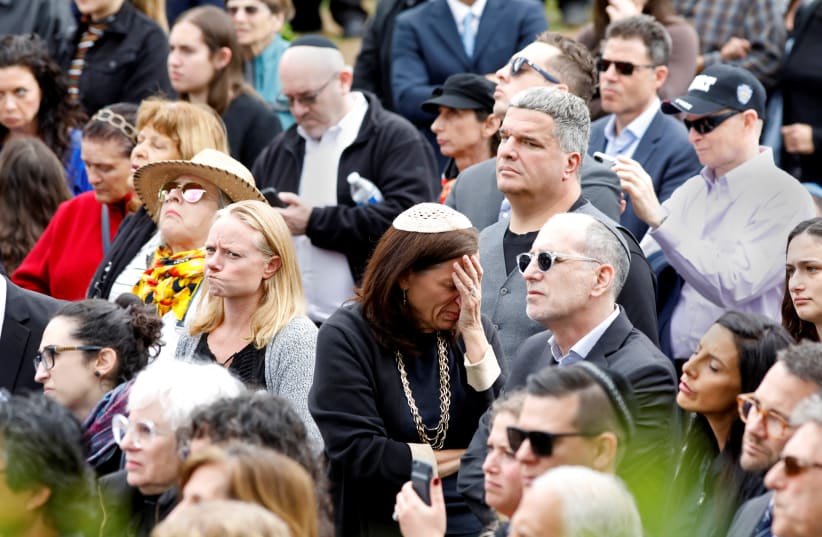 A crowd watches on screen the funeral for Lori Gilbert-Kaye, the sole fatality of the Saturday synagogue shooting at the Congregation Chabad synagogue in Poway, north of San Diego, California, U.S. April 29, 2019 (photo credit: JOHN GASTALDO/REUTERS)