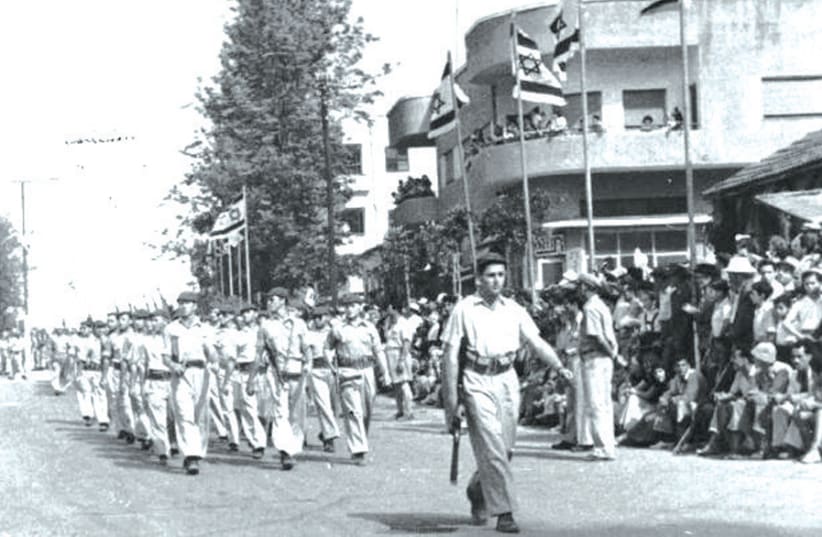 MEMBERS OF Kibbutz Gan Shmuel march on Israel’s second Independence Day, in Hadera in 1950. (photo credit: Courtesy)