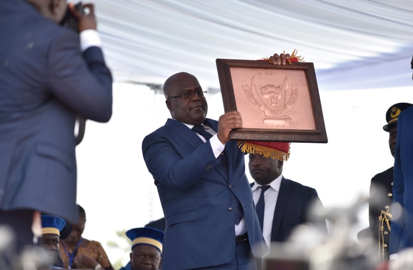Felix Tshisekedi holds the country's coat of arms during the inauguration ceremony whereby Tshisekedi was sworn into office as the new president of the Democratic Republic of Congo at the Palais de la Nation in Kinshasa, Democratic Republic of Congo, January 24, 2019 (photo credit: OLIVIA ACLAND/REUTERS)