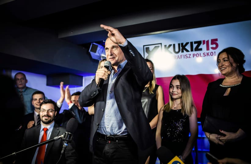 Pawel Kukiz of Kukiz '15 party addressess supporters after the exit poll results are announced in Warsaw, Poland October 25, 2015. (photo credit: REUTERS/AGENCJA GAZETA/ALBERT ZAWADA)